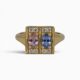 One 18 karat yellow gold claw and grain set sapphire and diamond ring.