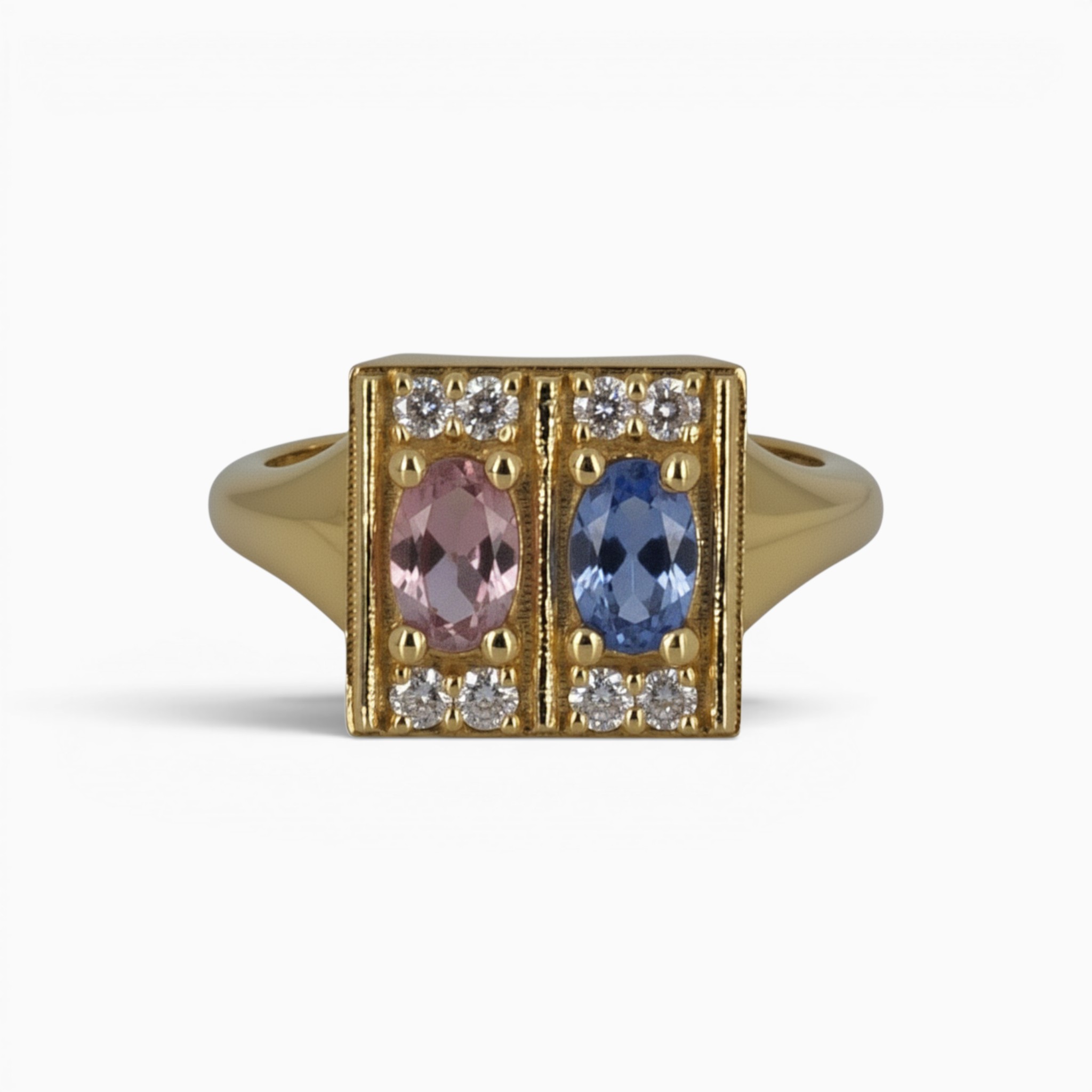 One 18 karat yellow gold claw and grain set sapphire and diamond ring.