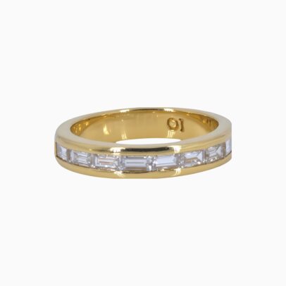 One 18 karat yellow gold channel set baguette diamond ring.