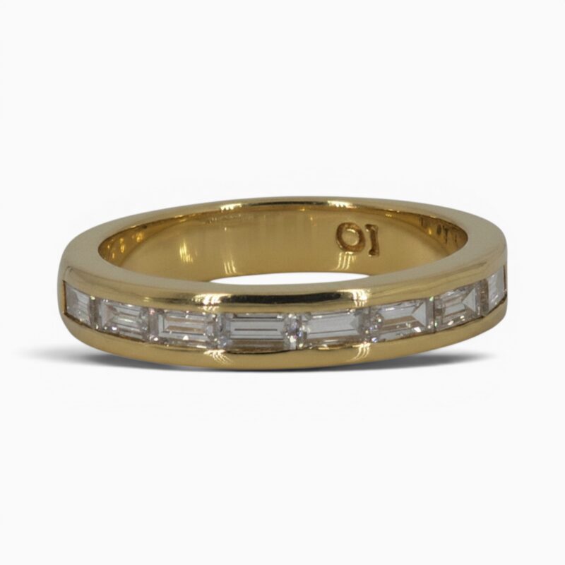 One 18 karat yellow gold channel set baguette diamond ring.
