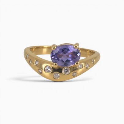One 18 karat yellow gold curved claw and rub set sapphire and diamond ring