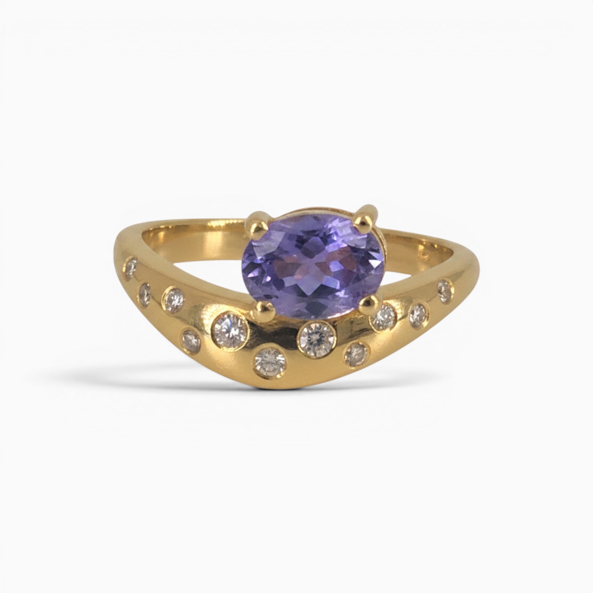 One 18 karat yellow gold curved claw and rub set sapphire and diamond ring