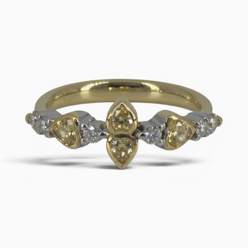 One 18 karat yellow and white gold rub and claw set alternating yellow and white diamond ring.