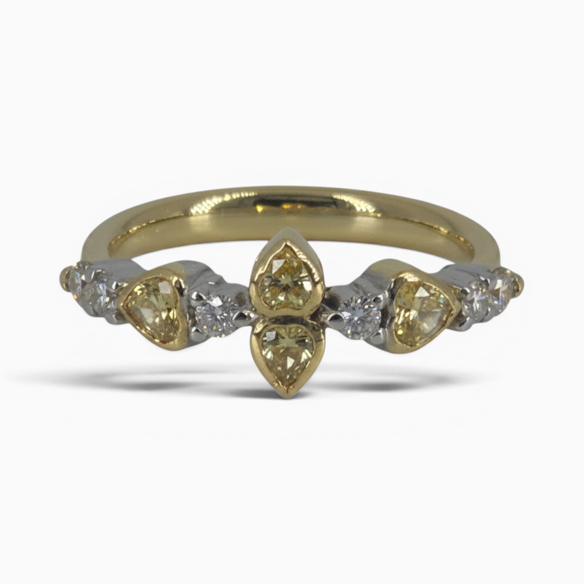 One 18 karat yellow and white gold rub and claw set alternating yellow and white diamond ring.