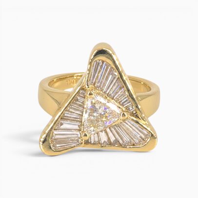 One 18 karat yellow gold channel and claw set flowing triangle diamond ring.