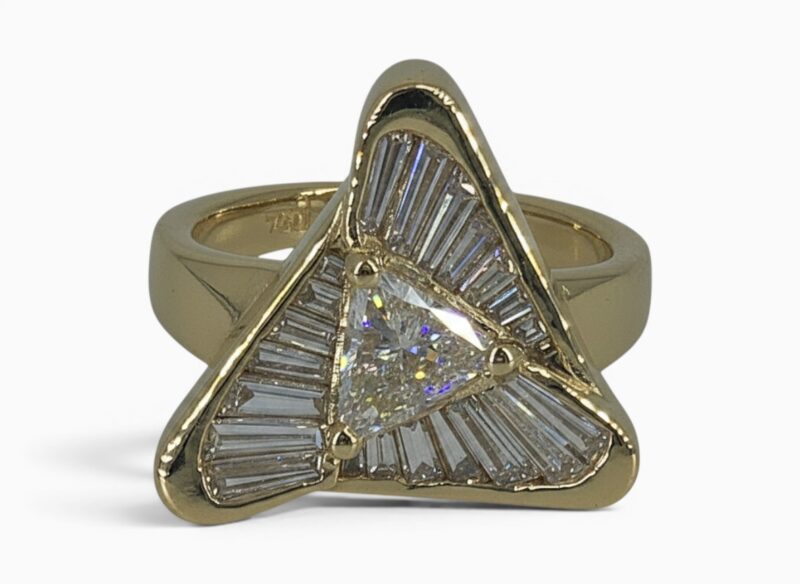 One 18 karat yellow gold channel and claw set flowing triangle diamond ring.
