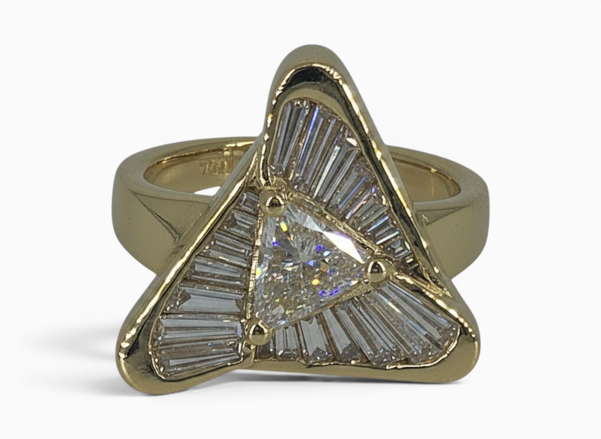 One 18 karat yellow gold channel and claw set flowing triangle diamond ring.