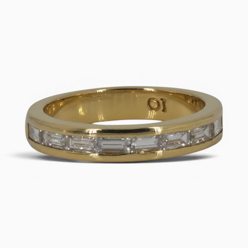 One 18 karat yellow gold channel set baguette diamond ring.
