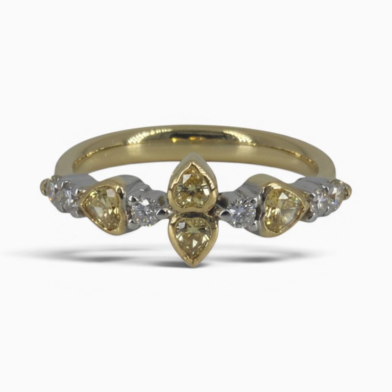 One 18 karat yellow and white gold rub and claw set alternating yellow and white diamond ring.